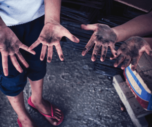 stock image of children displaying dirt on their hands